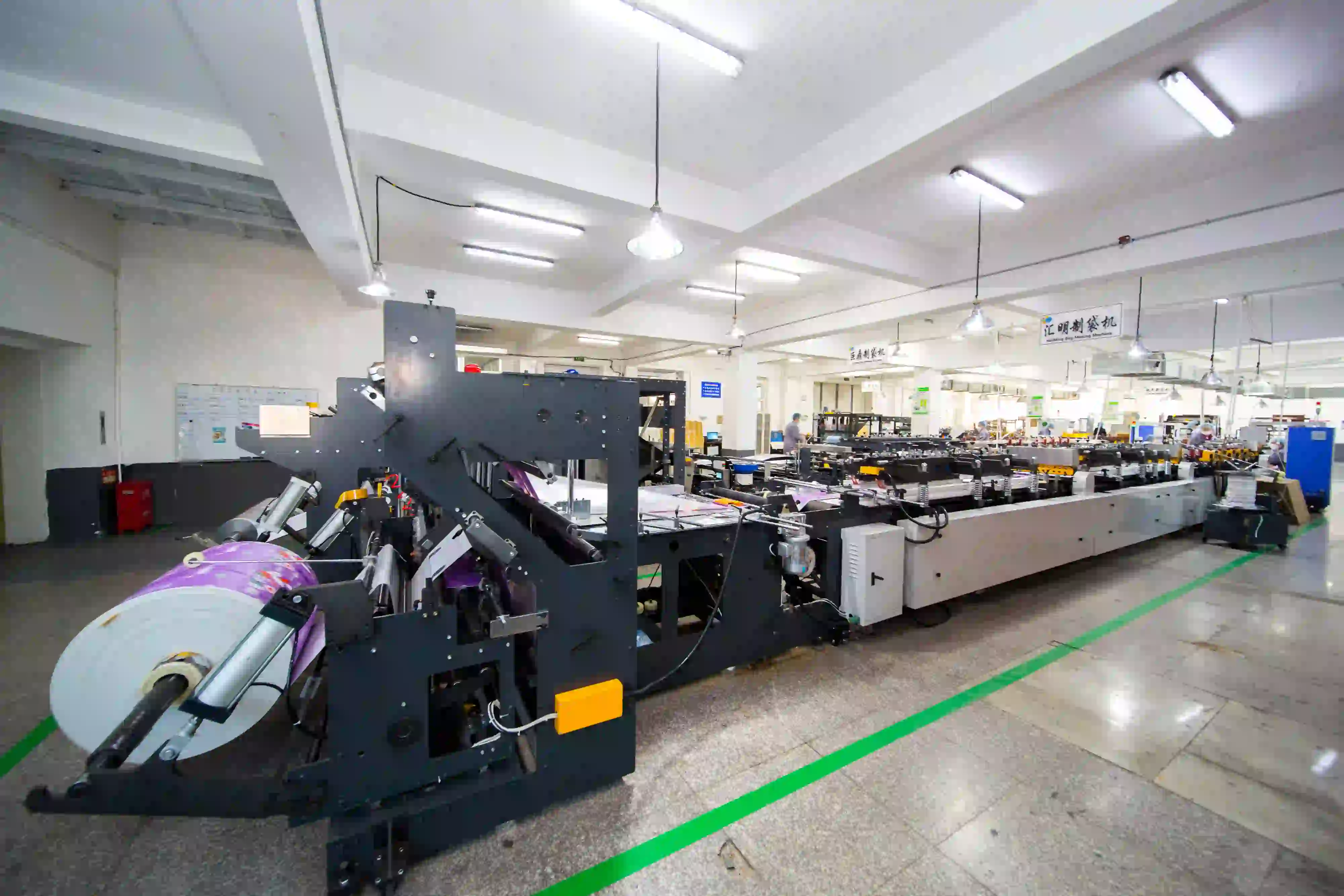 Automated pouch converting machine producing stand up pouches and coffee bags with integrated zipper and valve systems
